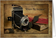 Retirement for photographer, vintage bellows camera with roll of film card