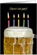 Birthday mug of beer with candles isolated on black card