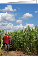 red farm tractor in cornfield with sky background card