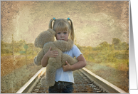 sad little girl with teddy bear on railroad tracks for Friendship card
