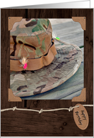 fishing hat and colorful fly framed on wood background for birthday card