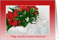 Christmas wedding-poinsettia bouquet and rings on Bible with candle card