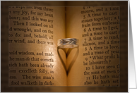 anniversary, wedding ring on Bible with heart shadow card