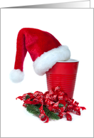 Santa’s hat on red party cup with holiday ribbon card