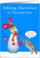 Christmas to Sister, Raccoon eating a candy cane with snowman, blue card