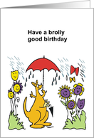Cartoon kangaroo enjoying rain shower with red umbrella and flowers card