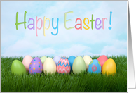 Colorful eggs in grass wishing Happy Easter card