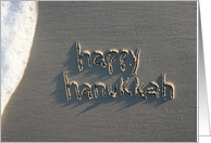 happy hanukkah, written in sand card