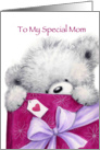 Cute bear holding a big present for mother’s birthday. card