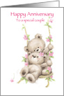 Cute bear couple on swing with flowers around, Happy Anniversary card