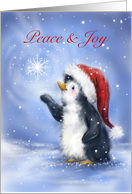 Cute penguin with Santa’s hat catching snowflake, peace & joy. card