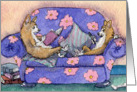 Corgi dogs sitting on sofa, reading a book and an ereader card