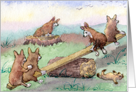 Welsh Corgi pups playing on a seesaw card