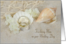 Mom’s wedding-rings in beach sand with seashells and net card