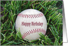 close up of a worn baseball in grass for birthday card