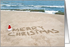 Sister’s Christmas, Merry Christmas written in sand with Santa hat card