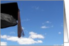 Black graduation cap with tassel in blue sky card