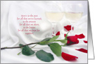 anniversary celebration with red rose and wine glasses on satin card