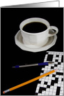 cup of black coffee with crossword puzzle and pencil card