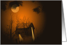 Haunted old cabin in woods with glowing orange moonlight card