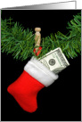 Christmas stocking with hundred dollar bill hanging by clothespin card