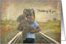 Thinking of you with sad child hugging a teddy bear on railroad tracks card