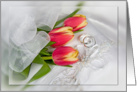 Anniversary tulip bouquet with silver rings on pillow card