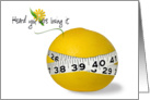 Weight loss encouragement-tape measure around a grapefruit on white card