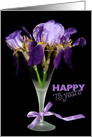 75th birthday purple iris bouquet in stemware isolated on black card