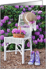 Birthday hat on wicker chair with purple sneakers in azalea garden card