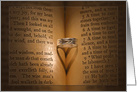 anniversary, wedding ring on Bible with heart shadow card