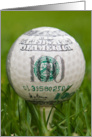 close up of a golf ball on a tee in grass for birthday card