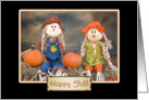 autumn scarecrows sitting on hay bale with pumpkins for happy fall card