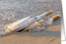 Merry Christmas message in a bottle on the beach card