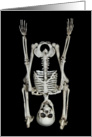 Halloween-skeleton standing on its head isolated on black card