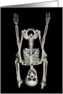Halloween-skeleton standing on its head isolated on black card