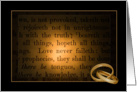 gold wedding rings on Bible verse with dark vignetting card