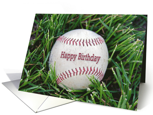 close up of a worn baseball in grass for birthday card (1290434)