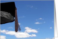 Black graduation cap with tassel in blue sky card