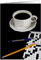 cup of black coffee with crossword puzzle and pencil card