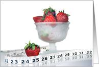 Weight loss encouragement with tape measure and strawberries. card