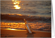 Hello message in a bottle on the beach at sunset card