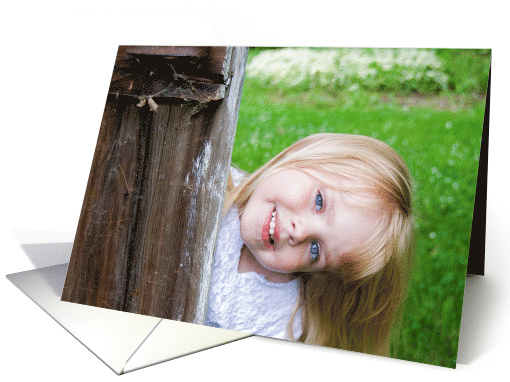 Hello, smiling little girl peeking around old wooden door card