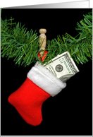 Christmas stocking with hundred dollar bill hanging by clothespin card