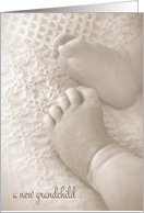 new grandchild congratulations with soft baby feet in sepia card