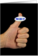thumb’s up-man’s thumb with inspirational sticker on black card