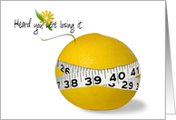 Weight loss encouragement-tape measure around a grapefruit on white card