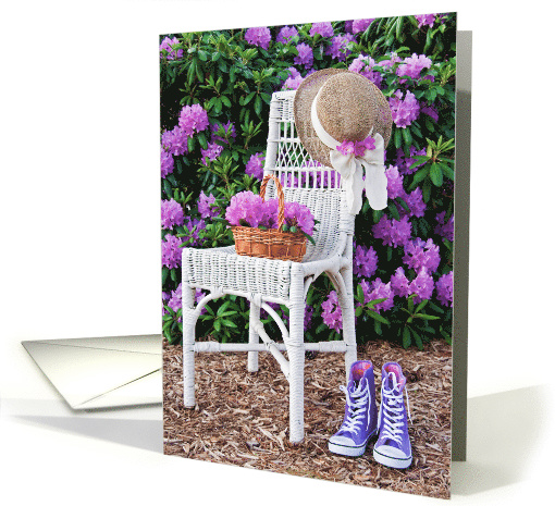 Birthday hat on wicker chair with purple sneakers in... (826326)