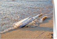 Happy Birthday message in a bottle on a beach card