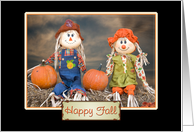autumn scarecrows sitting on hay bale with pumpkins for happy fall card